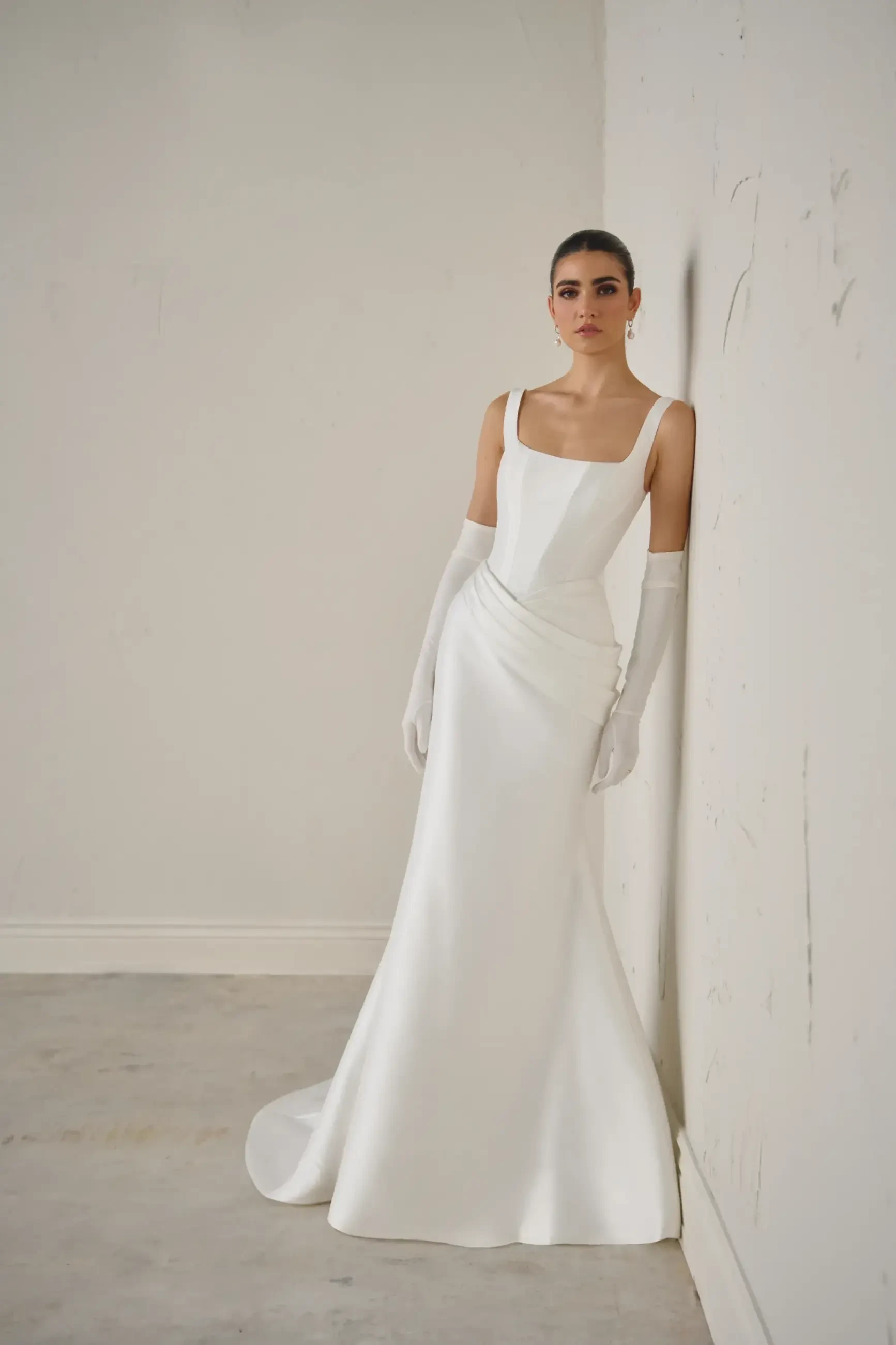 model is wearing a sleeveless mikado bridal gown