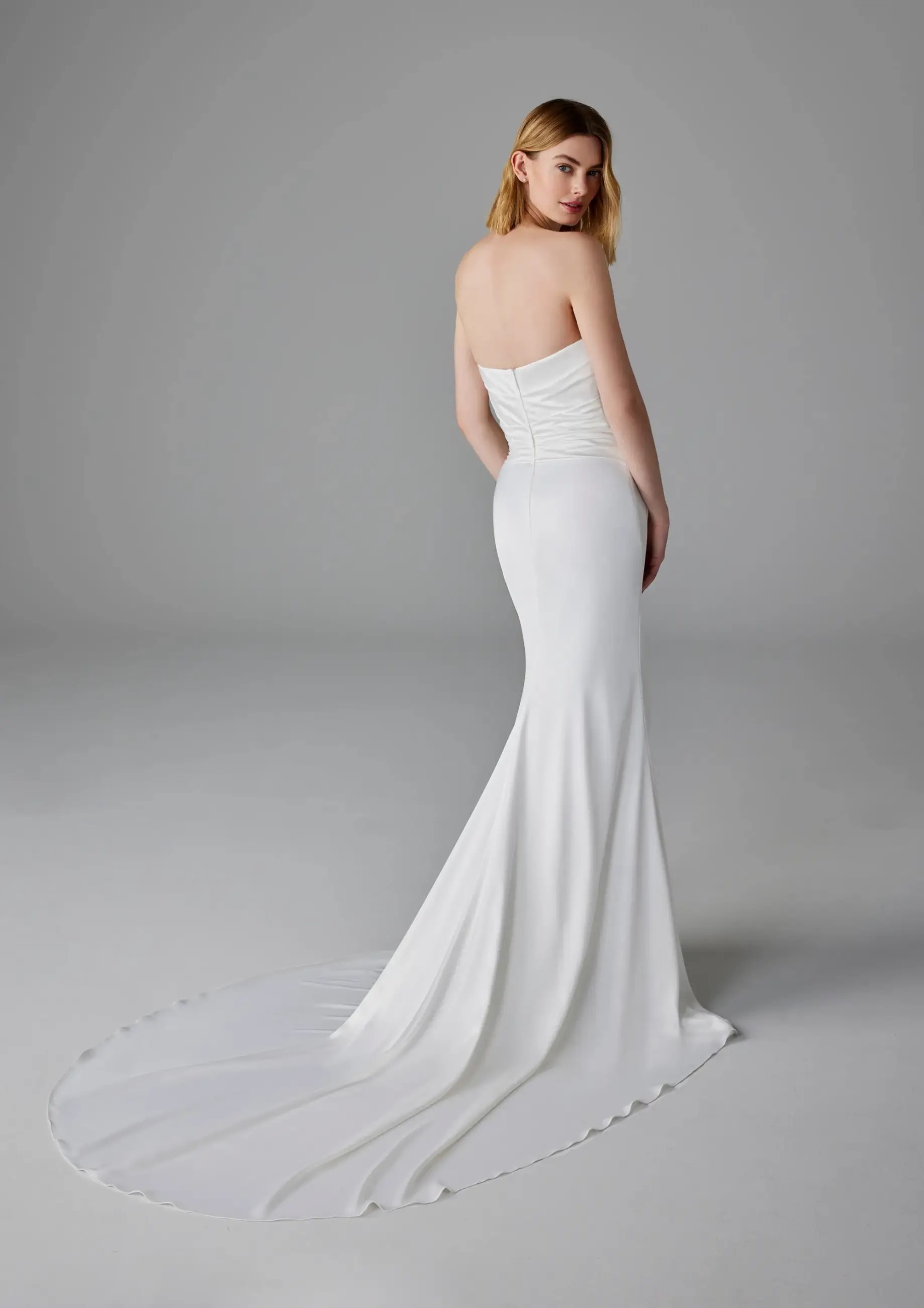 Model is wearing a satin mermaid bridal gown by pronovias