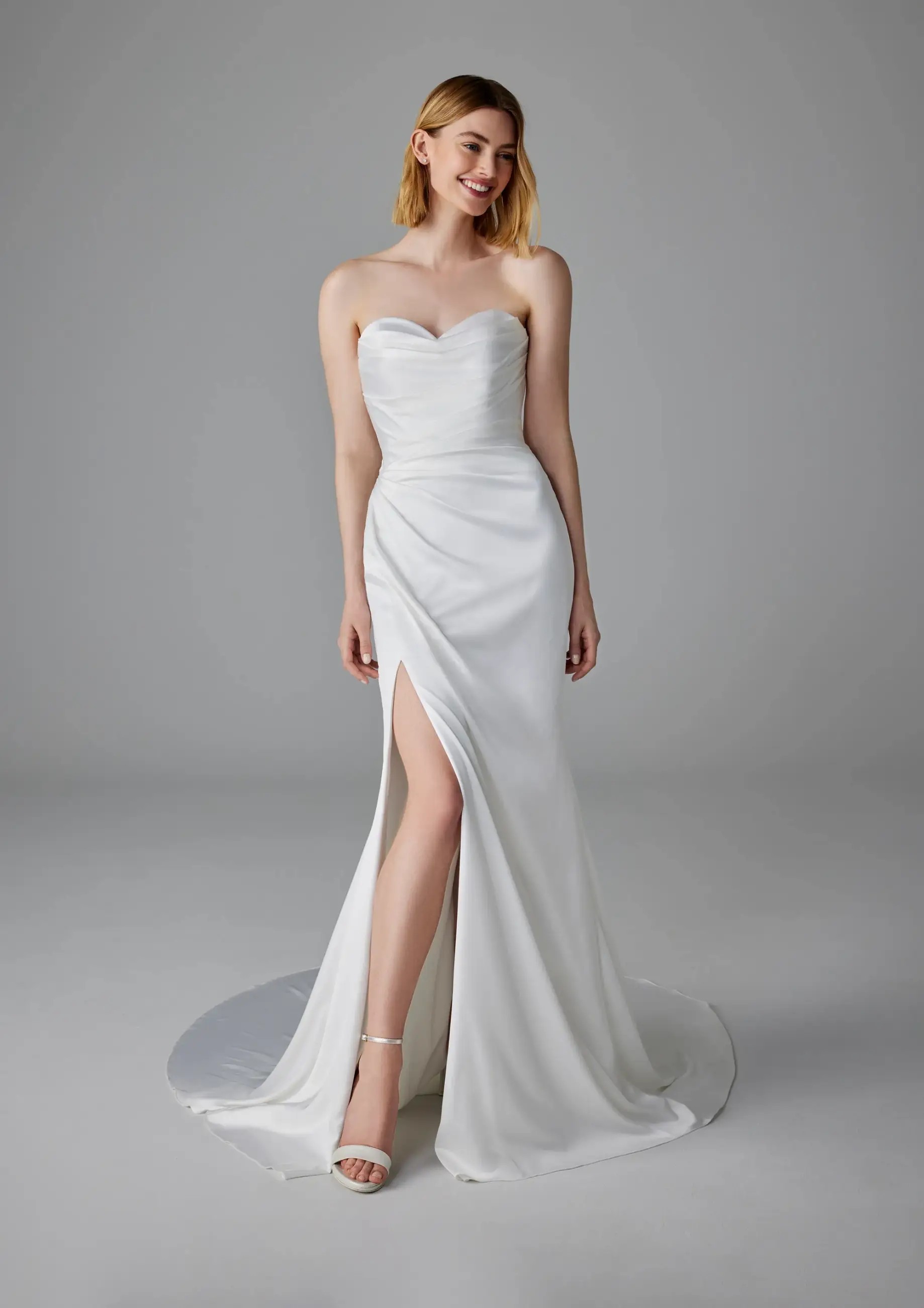 Model is wearing a satin mermaid bridal gown by pronovias