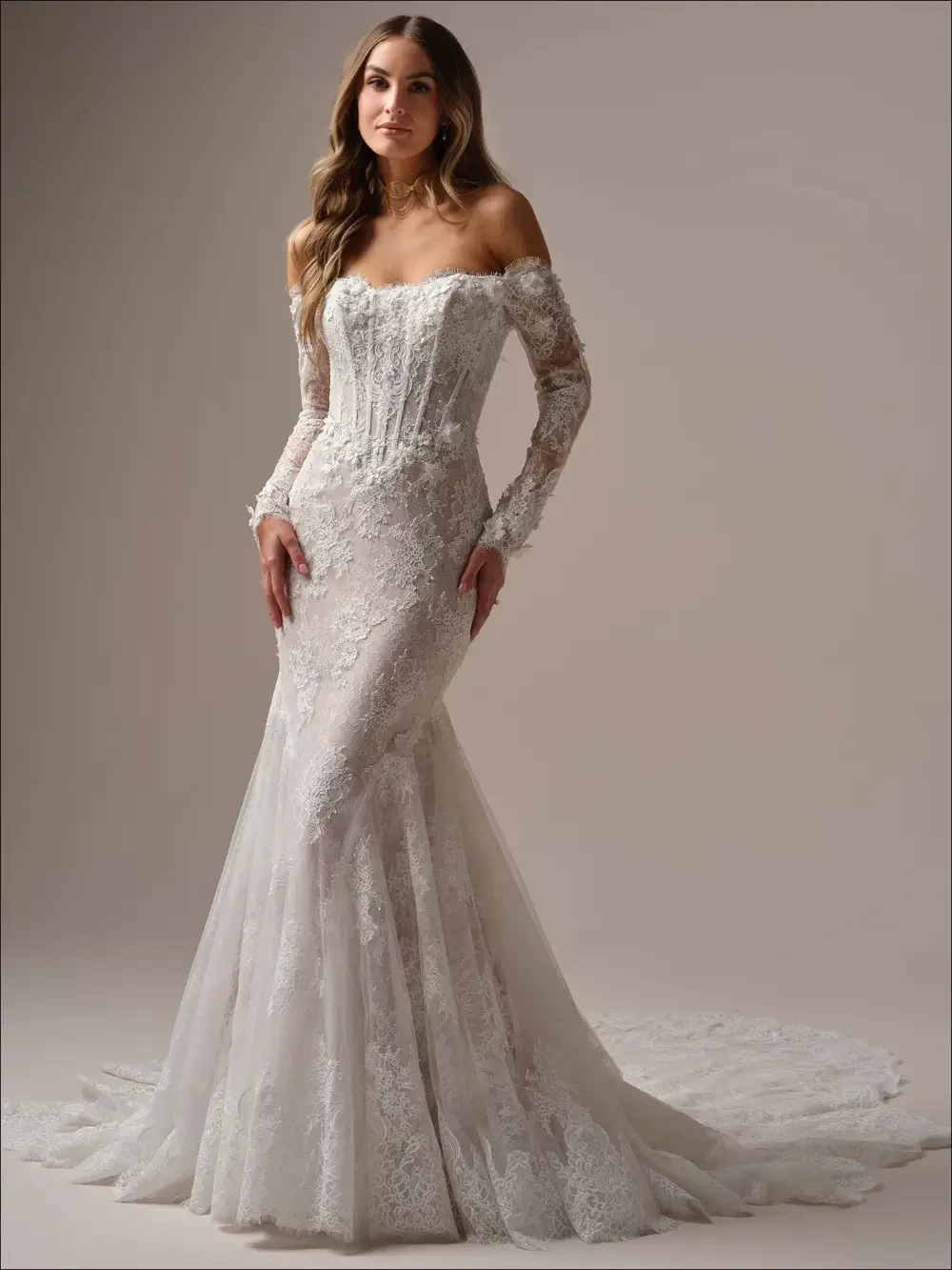 model is wearing an off the shoulder lace bridal gown
